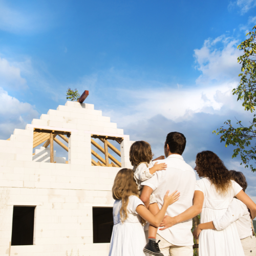 Happy family standing in front of their new home in the Dallas-Fort Worth area.